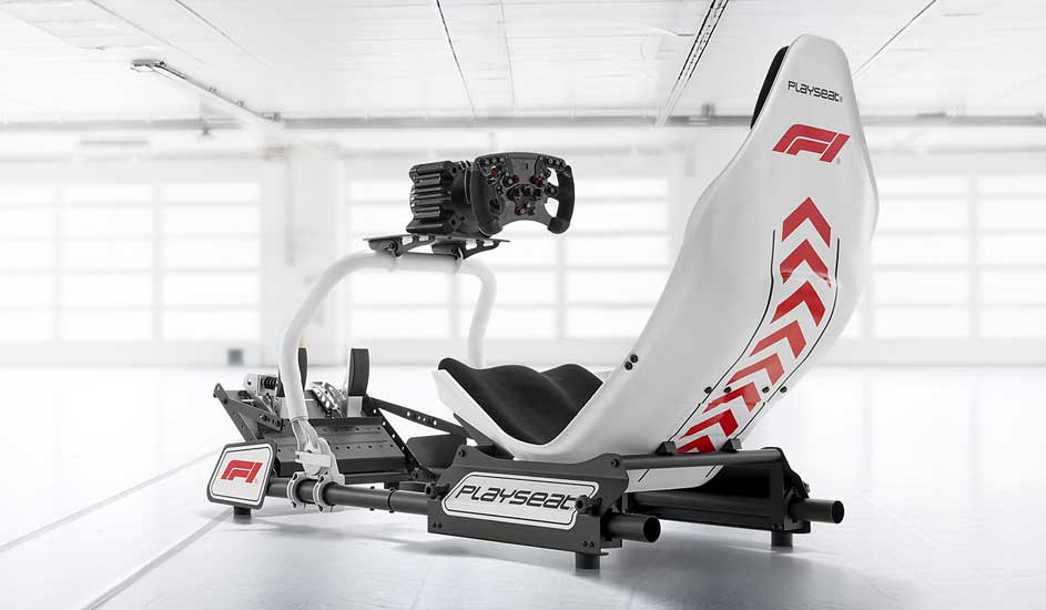 A sleek white F1 racing simulator seat with red graphics, mounted on a black frame with wheel and pedals, stands ready in a bright studio.