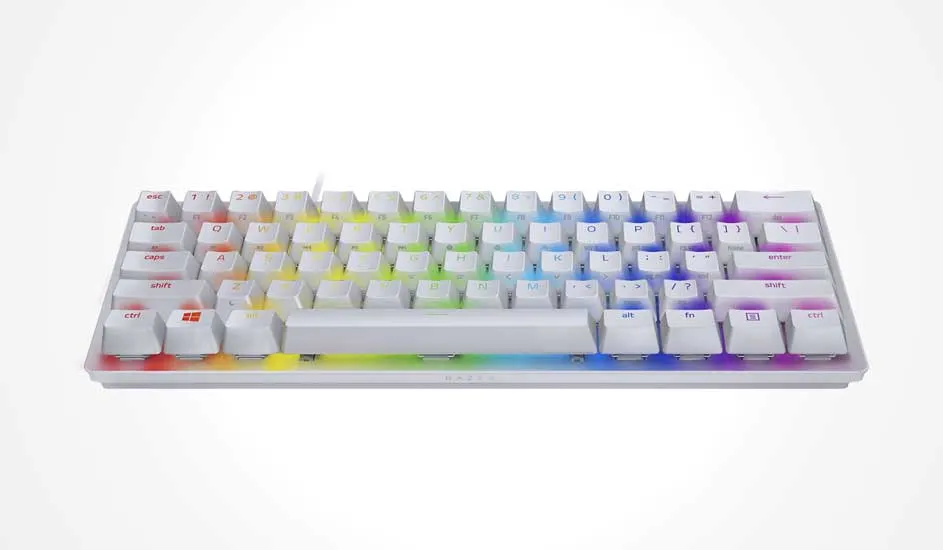 Compact white mechanical keyboard with tall keycaps, soft rainbow glow between them and a slim frame that keeps the gaming setup bright.