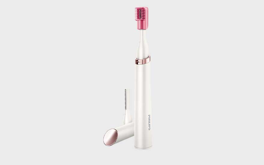 A white and pink Philips trimmer with two attachments, perfect for precise hair removal, is shown standing upright.