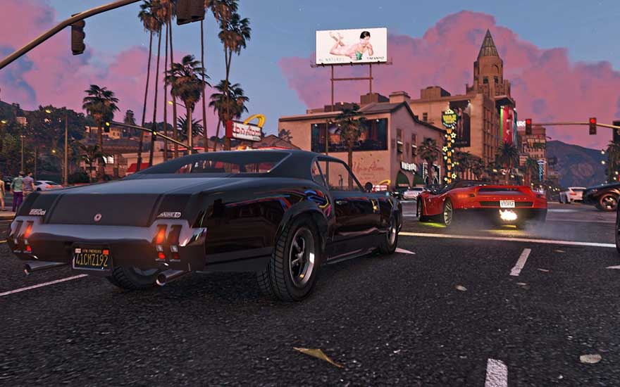 Evening traffic in a lively city as two sports cars cruise past palm trees and neon adverts beneath a pink sky.
