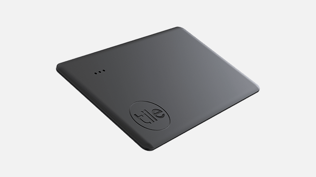 Een grijs vierkant apparaat met afgeronde hoeken en een 'tile'-logo in de hoek, op een witte achtergrond.