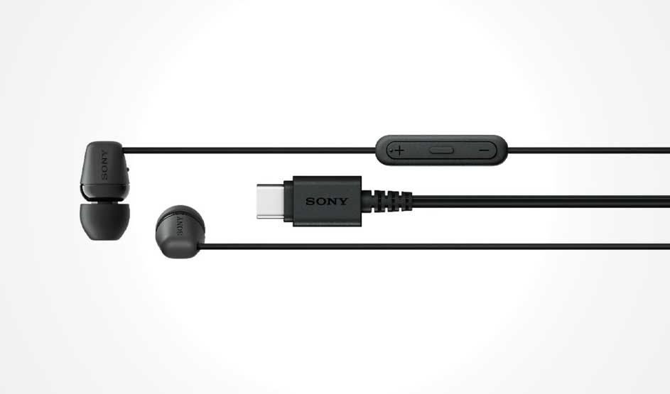 Zwarte Sony in-ear oordopjes met USB‑C aansluiting en slanke afstandsbediening, plat naast elkaar gelegd op een heldere witte achtergrond.