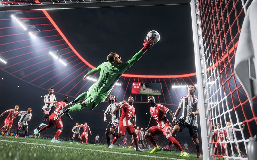 Dramatic goalkeeper save during football match with green keeper diving spectacularly towards ball in the goal