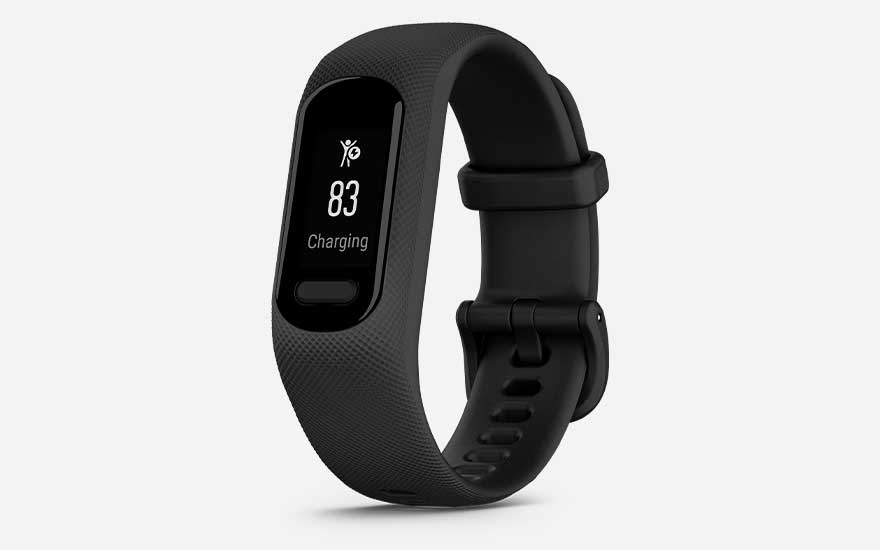 Compact black fitness band with subtle texture, featuring a small monochrome screen showing high activity score and charging status.