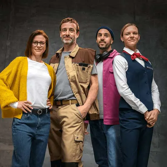 Four people in varied workwear stand confidently together, from casual clothes to formal uniform, representing several modern professions.
