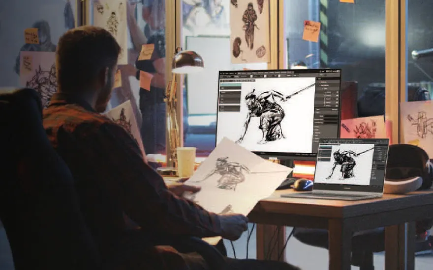 Kunstenaar werkt aan digitale tekeningen op laptop en tablet, schetst krijger figuren, atelier vol kunstwerken en referenties aan muur.