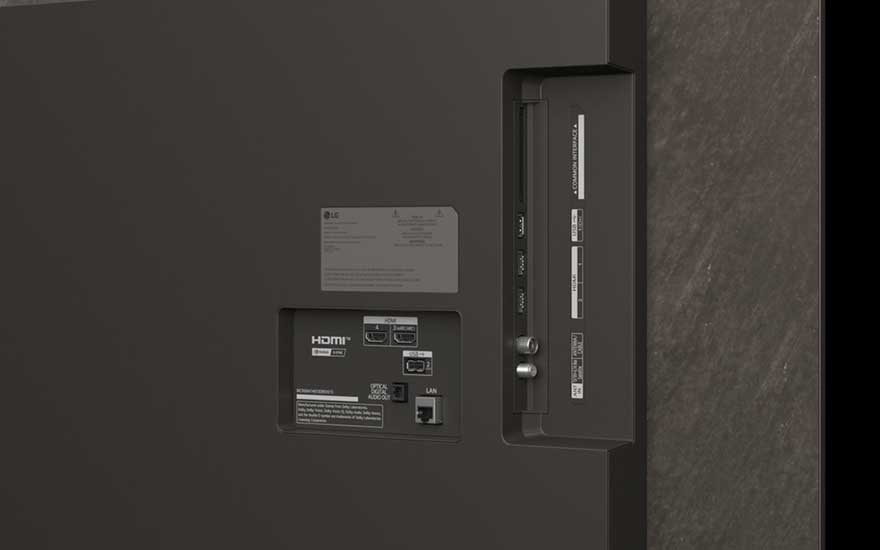 Close-up of the back of a TV shows various ports, including HDMI, LAN, USB, and antenna connections for different devices.