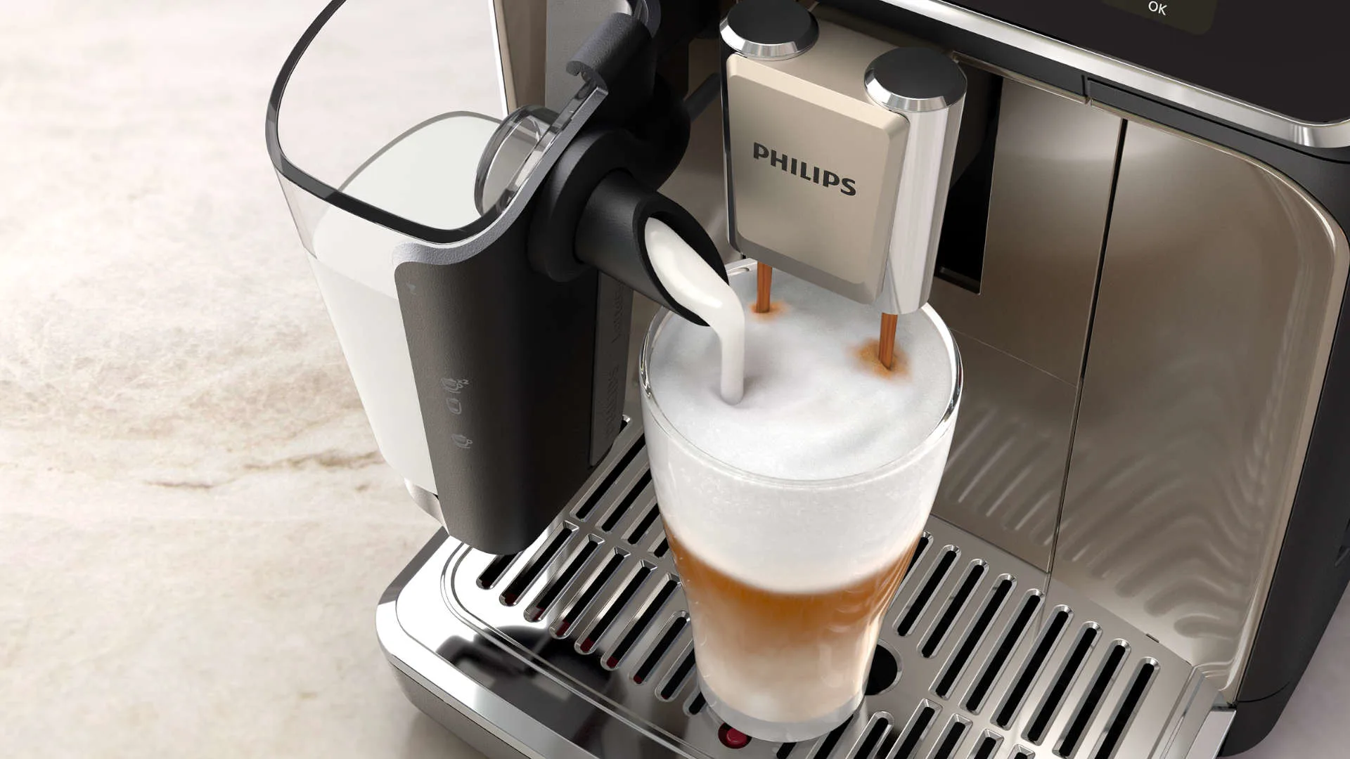 Een Philips koffiemachine vult een glas met melk en koffie op een metalen rooster.