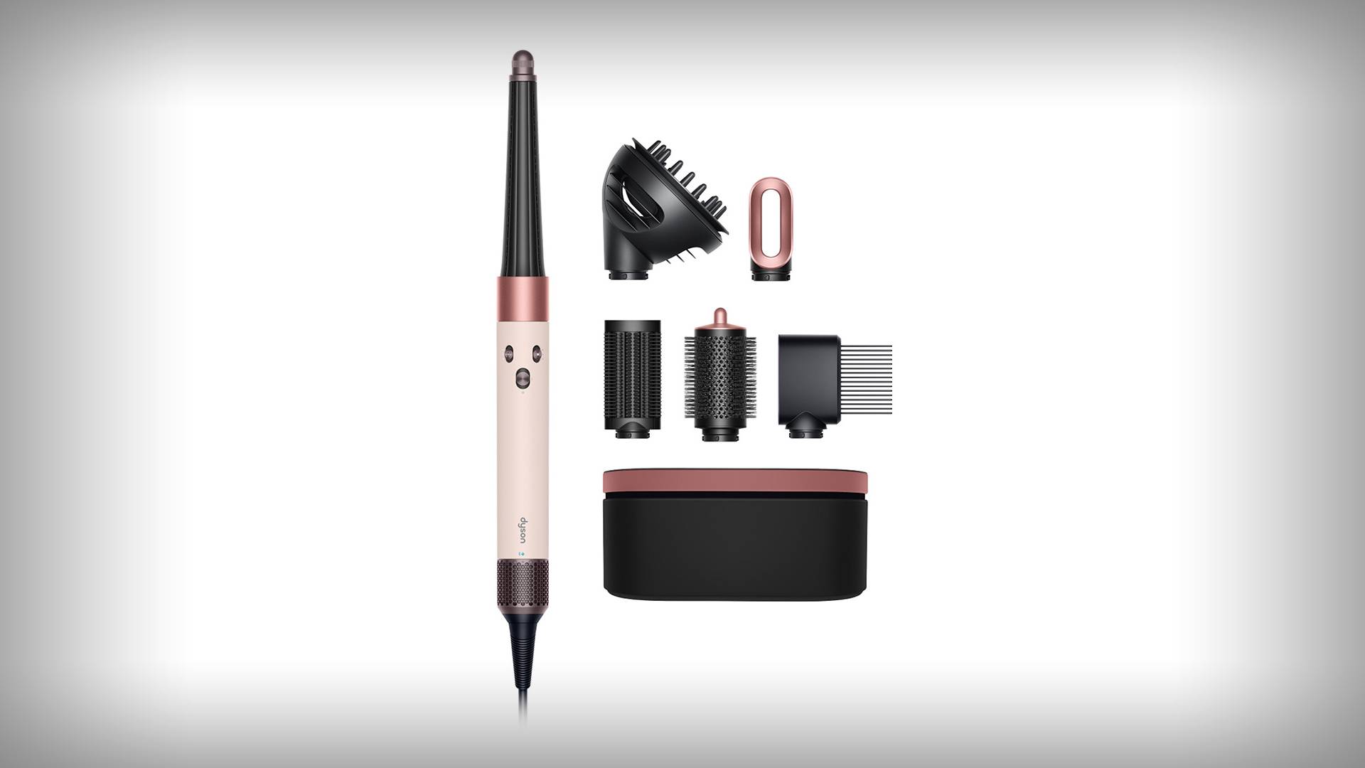 Roségouden en zwarte haarstyler met vijf opzetstukken en een opbergdoos overzichtelijk op een witte achtergrond.