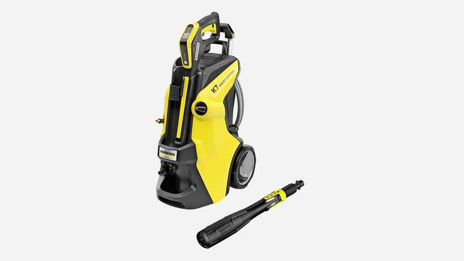A yellow Kärcher K7 pressure washer with wheels and a detached black spray nozzle is displayed on a plain background, ready for cleaning.