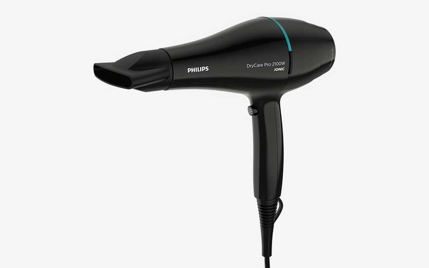 Black Philips DryCare Pro hairdryer with slim nozzle shown sideways on a light background, power cord hanging neatly downwards.