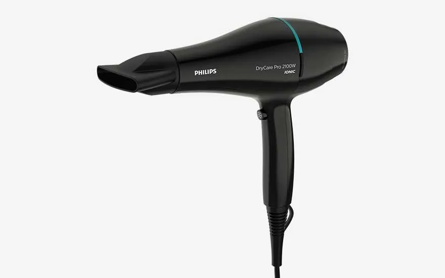 Black Philips DryCare Pro hairdryer with slim nozzle shown sideways on a light background, power cord hanging neatly downwards.