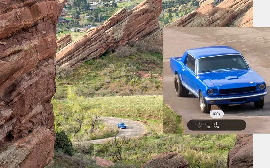 Mountain landscape with red rocks shows phone zoom function, blue classic car drives through valley with 100x zoom displayed.