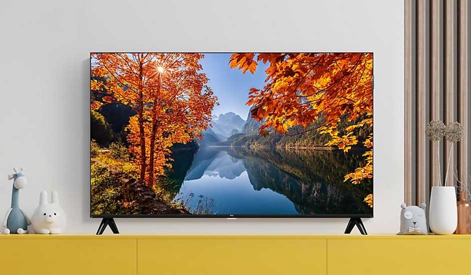 A Xiaomi TV on a yellow cabinet shows an autumn lake and mountains; cute toys and vases sit beside it in a tidy room.
