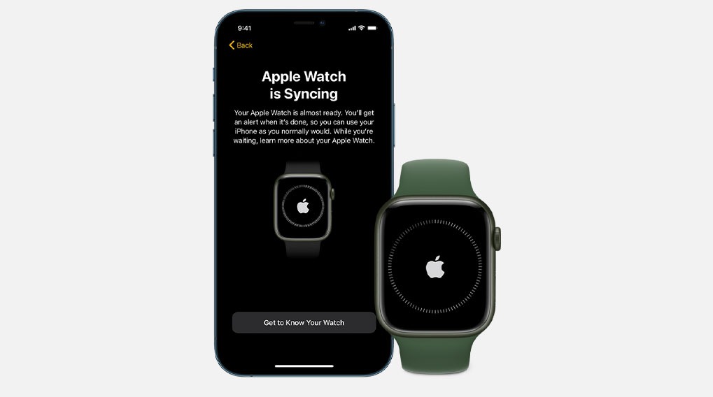 A smartphone displays "Apple Watch is Syncing" next to a watch with a green band.