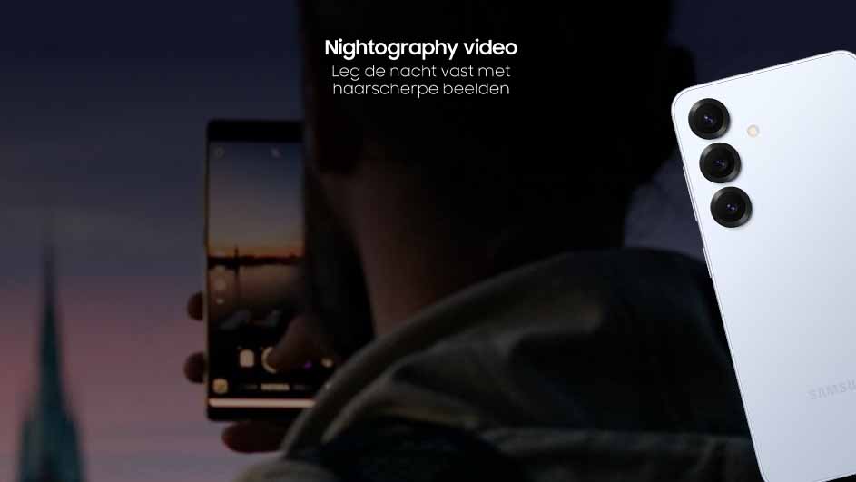 Een persoon houdt een telefoon vast en maakt een foto van een stadsgezicht bij zonsondergang, terwijl een tweede telefoon zichtbaar is.