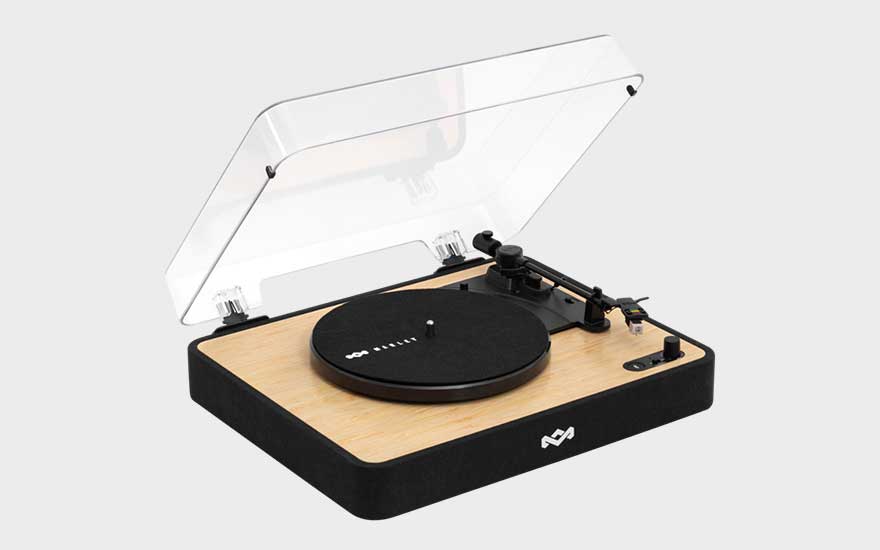 A turntable with a wood-finish base and transparent dust cover is shown open on a clean, neutral background.