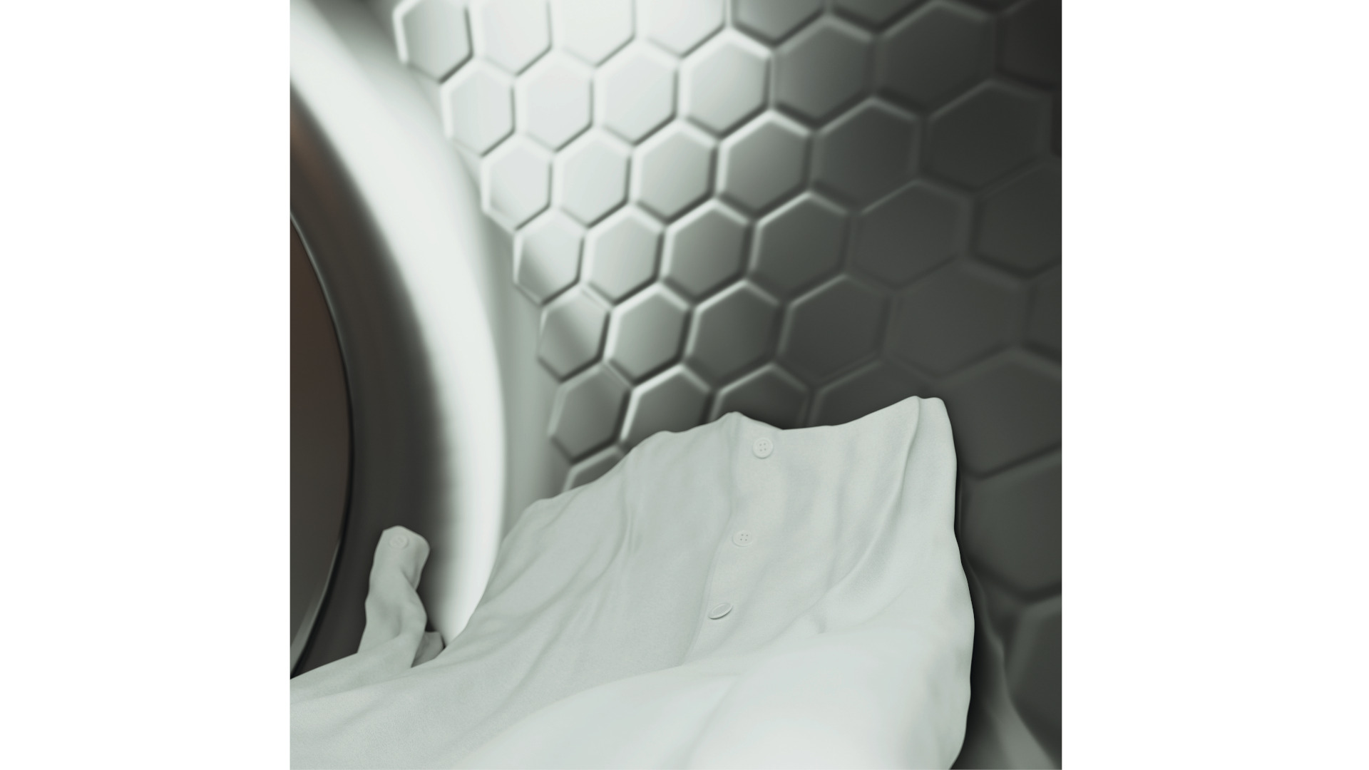 Een witte blouse met knopen ligt in een wasdroger met een honingraatpatroon aan de binnenkant.