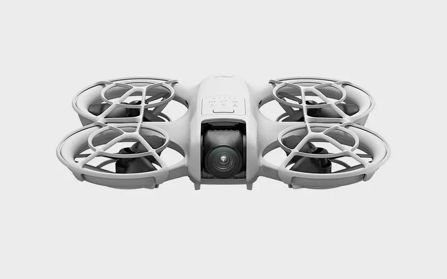 Een innovatieve drone met beschermde propellers en witte behuizing wordt frontaal getoond op een effen achtergrond.