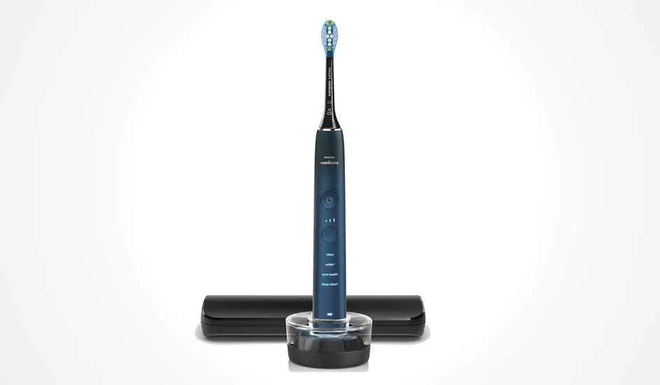 Een donkerblauwe Philips Sonicare elektrische tandenborstel staat op een oplader, met een zwart reisetui erachter. Modern en strak ontwerp.