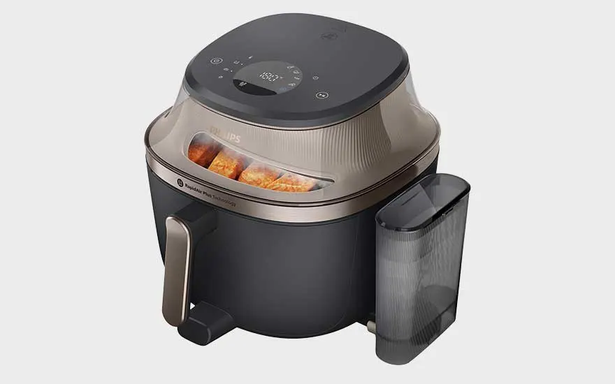 Een moderne Philips-airfryer met doorzichtig venster, digitaal bedieningspaneel en apart reservoir ernaast.