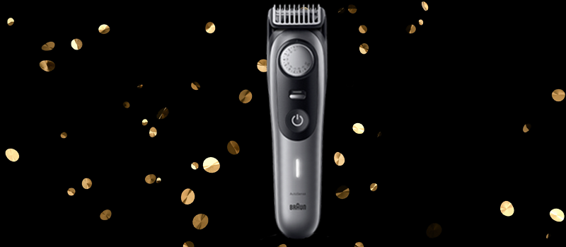 Op de afbeelding staat een zilveren Braun trimmer centraal, met gouden confetti op een zwarte achtergrond voor een feestelijk effect.