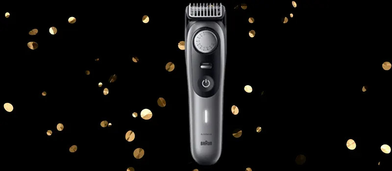 Op de afbeelding staat een zilveren Braun trimmer centraal, met gouden confetti op een zwarte achtergrond voor een feestelijk effect.