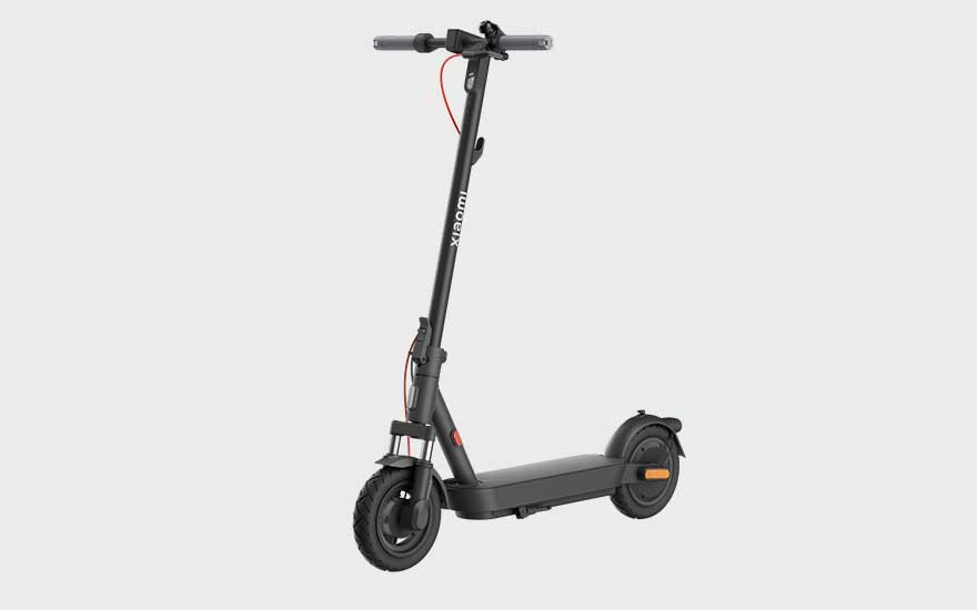 A sleek matte black Xiaomi electric scooter with red accents and robust tyres, ready for daily city use and easy transport.