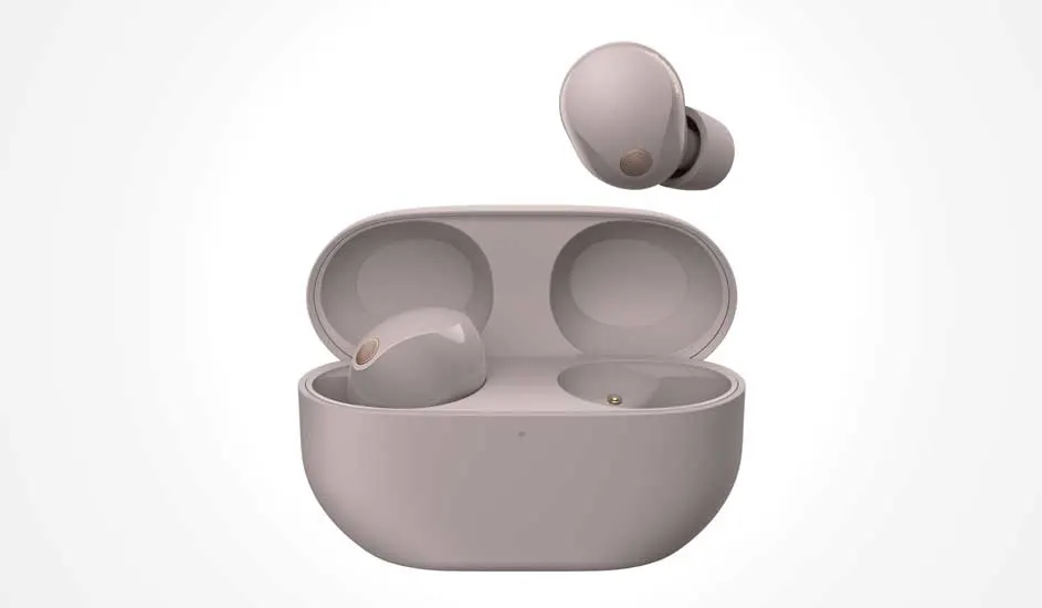 Light pink wireless earbuds with an open rounded charging case; one earbud rests inside, another floats just above.