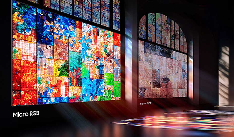 A futuristic display room showcases two large screens featuring vibrant Micro RGB technology. On the left, a colourful mosaic pattern in red, blue, yellow and green. Modern technology demonstration space.