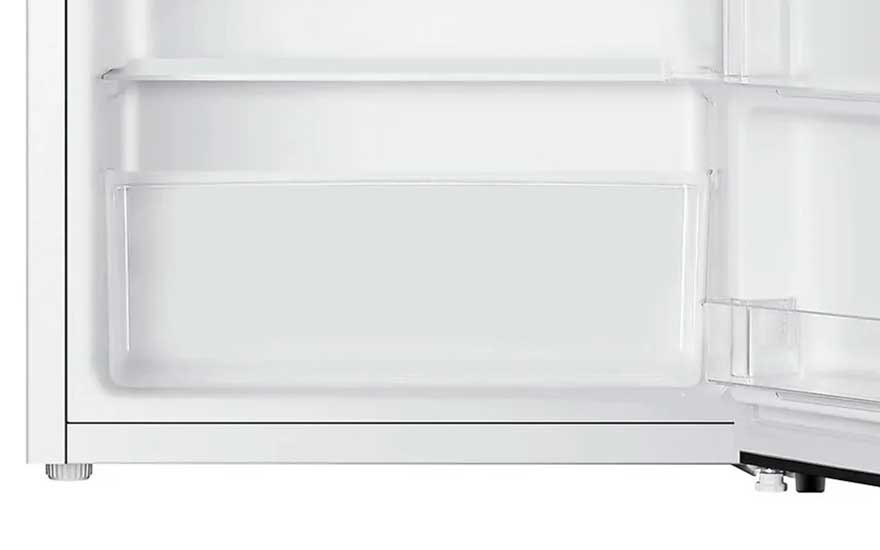 Lower part of a fridge door showing wide door bins and a white interior, with the floor edge and an adjustable foot visible.