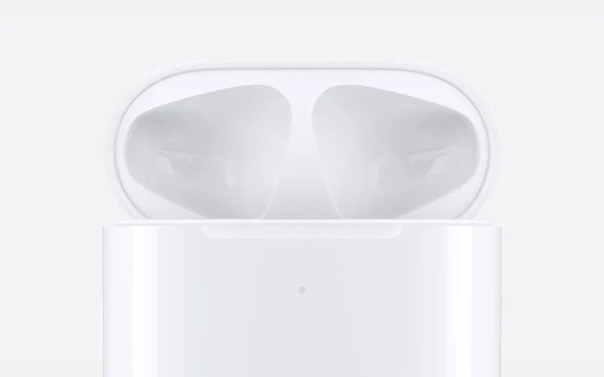 Close up of a glossy white AirPods charging case, shown empty inside and ready to hold the earbuds, captured in a clean minimal style.