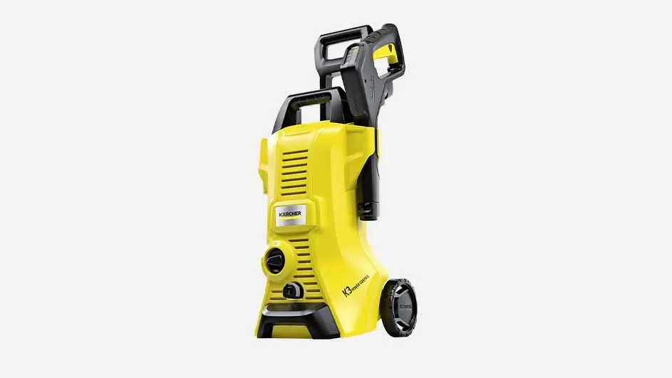 A yellow Kärcher K3 pressure washer with black details and wheels is standing upright on a white background, ready for outdoor cleaning.
