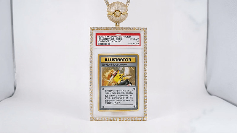 Japanese Pokémon card "Illustrator" in a diamond frame, hanging from a gold Pokéball chain, rare collector's item.