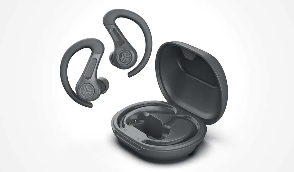 Dark grey sport earbuds with ear hooks float beside a round open charging case, made for a secure fit during energetic workouts.