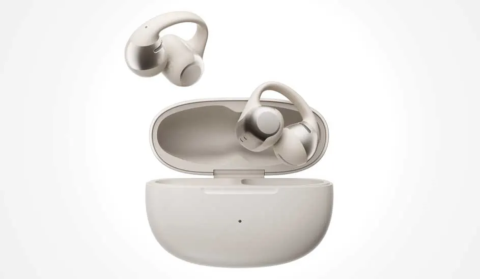 Cream true wireless earbuds with ear hooks, one resting inside an open charging case while the other hovers delicately above it.