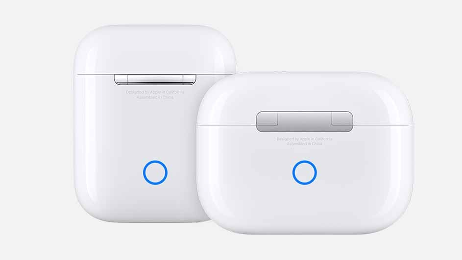 Two white earbud cases sit on a white surface. Each has a gray accent and a blue circle on the front.