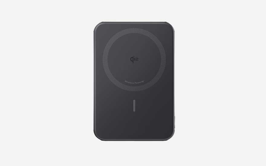 Sleek black wireless power bank with circular charging ring and minimal LED indicator, made for magnetic charging of modern phones.