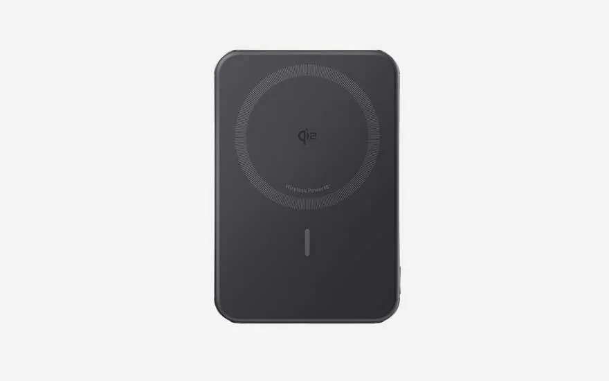 Sleek black wireless power bank with circular charging ring and minimal LED indicator, made for magnetic charging of modern phones.