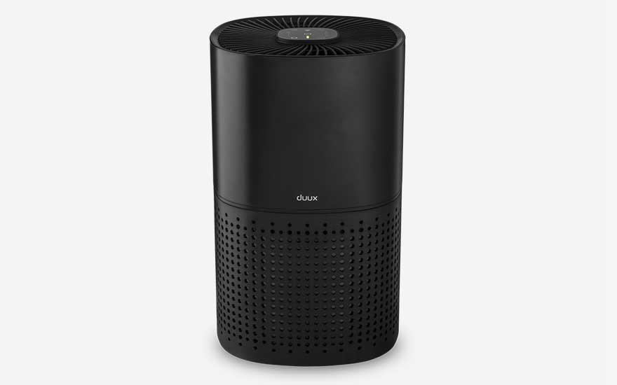 A sleek cylindrical black Duux Bright Smart air purifier stands against a light background, featuring a perforated lower section for air intake.