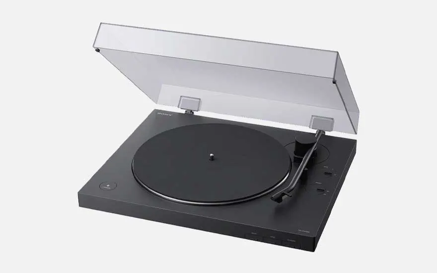 Sleek black plastic turntable with clear lid, minimalist controls and tonearm on the right, shown against a pale background.