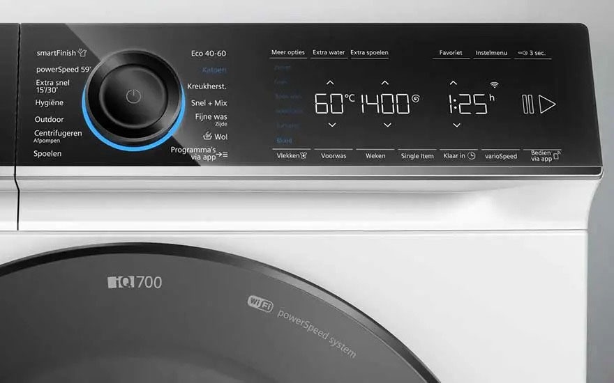 The control panel of a washing machine displays various wash programmes like 'Cotton' and 'Mix', with settings for temperature (60°C) and spin speed (1400). A display shows the remaining time (1:25).