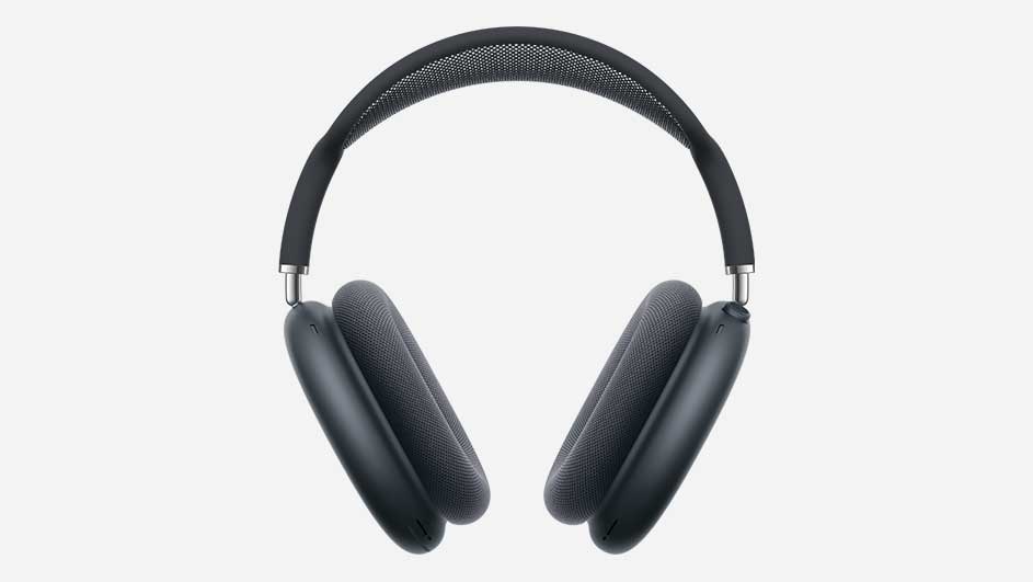 A dark grey over‑ear headphone with a wide cushioned headband and oval ear cups is shown standing upright against a clean, light background.