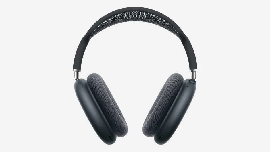 A dark grey over‑ear headphone with a wide cushioned headband and oval ear cups is shown standing upright against a clean, light background.