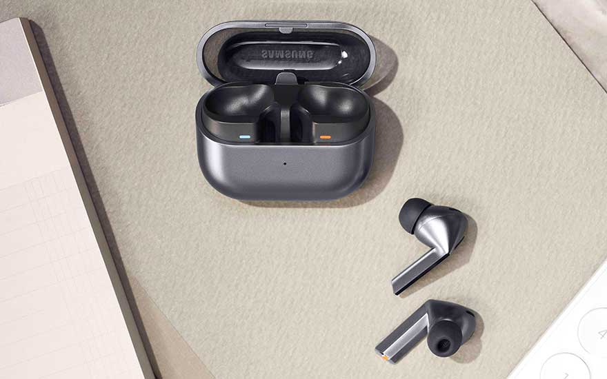 Een open oplaadcase met draadloze oordopjes ligt op een bureau, met twee losse earbuds ernaast in een moderne metallic afwerking.