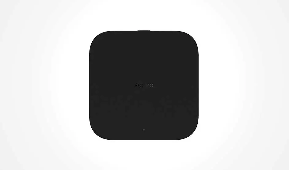 Een compact zwart Aqara-apparaat met afgeronde hoeken staat frontaal afgebeeld tegen een lichte, effen achtergrond.