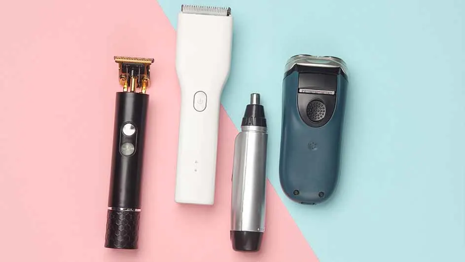 The image displays four grooming tools on a split pink and blue background. There is a black trimmer, a white clipper, a silver nose trimmer, and a blue electric shaver.
