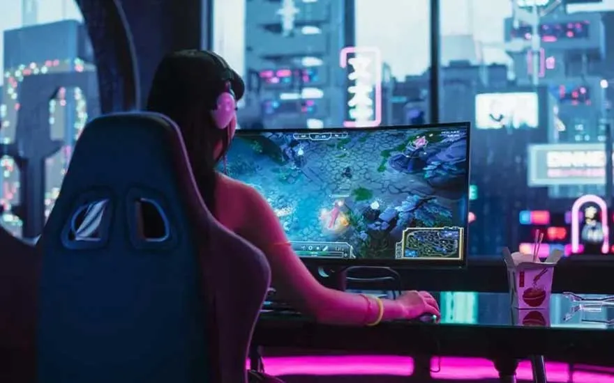 A gamer wearing headphones plays on a curved monitor, bathed in neon lights with a futuristic city skyline visible through the window.