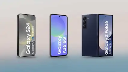 A light blue smartphone lies beside a black phone with colourful screen on a white marble surface, both featuring multiple camera modules.