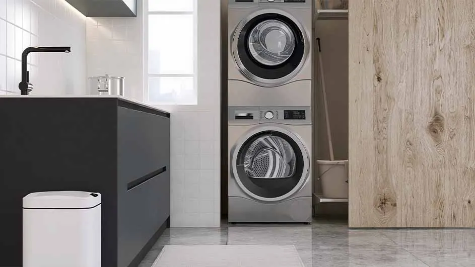 A laundry room scene features a stacked washer and dryer next to a dark cabinet and white trash can. A light wood door is visible.